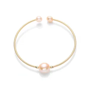 Macro shot of 14K gold-filled spiral wire bracelet with three lustrous pink pearls