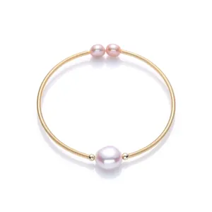 Detail of 14K gold-filled cuff bracelet with a large baroque pearl and two side pearls