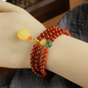 Three-layer red agate bead bracelet with amber rose charm and green strawberry crystal