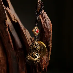 Handcrafted hollow brass gourd keychain with ancient coin and braided cord pendant