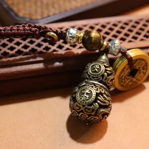 Handcrafted brass gourd keychain with tiger eye stone and vintage coins for good luck