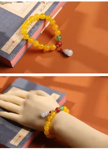 Detail view of natural green agate beads bracelet with a small white gourd pendant charm
