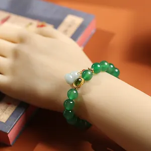 Natural green agate bead bracelet with a jade gourd pendant on a model's wrist