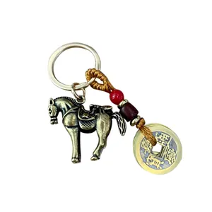 Vintage brass horse keychain with Jiaqing Tongbao coin and red bead on a white background