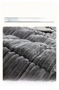 Macro shot of thick grey-purple flannel sofa cover with linear quilting and plush texture