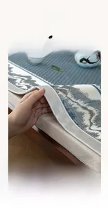 Close-up of wide-edge stitching and mountain print on cooling ice silk sofa mat