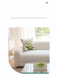 Detail of ice silk cooling sofa cover with wave texture and green floral embroidered pillow