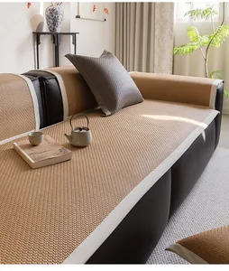 Detail of the woven PE ice rattan cooling sofa mat texture with clean white leather piping
