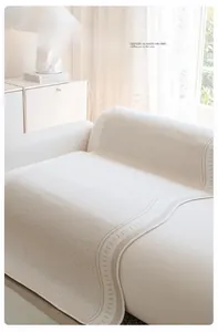 Detail of cream ice silk sofa cover with herringbone texture and wavy stitched edges