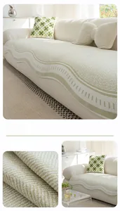 Close-up of green cooling ice silk sofa cover with wavy knit texture and non-slip fabric