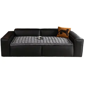 Modern black leather sofa with grey quilted velvet cushion and yellow leopard pillow