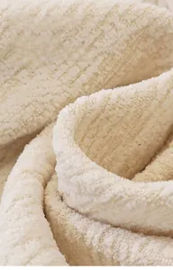 Close-up of cream chenille sofa cover showing thick vintage woven texture and softness
