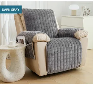Close-up of dark gray plush quilted recliner cover with side storage pocket details