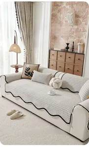 Detailed close-up of textured chenille sofa cover with fringe trim and check pattern