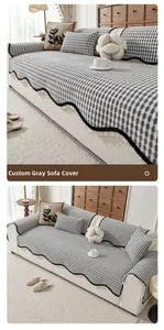 Close-up of grey chenille sofa cover with black lace trim and plaid pattern