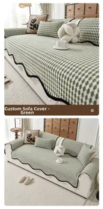 Close-up of green checkered chenille sofa cover with black wavy ruffled edge detail
