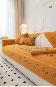 Detail of bohemian chenille sofa cover with yellow geometric patterns and star motifs
