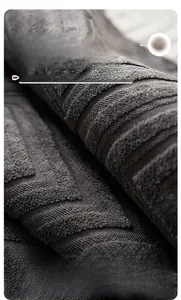 Close-up of deep grey chenille fabric with premium 3D jacquard wave texture and soft fibers