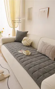 Detail of grey chenille sofa cushion with premium quilted square patterns and soft texture