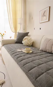 Close-up of thick dark grey chenille sofa cover with quilted plaid texture and soft feel