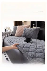Detail of grey quilted rabbit fur sofa cover with high-density plush texture and stitching