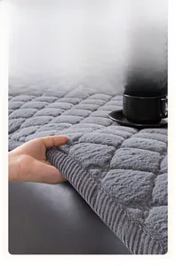 Close-up of gray plush sofa cover showing thick cotton piping and soft faux rabbit fur