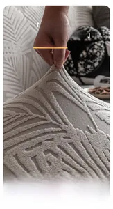 Close-up of thick elastic sofa cover fabric with embossed leaf pattern and stretch detail