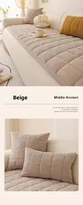 Detailed view of beige chenille sofa cushion with quilted herringbone texture and pillow