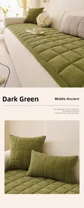 Detail of dark green chenille sofa cushion with quilted herringbone texture and soft fabric
