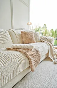 Detailed view of thick plush sofa cover with wave texture and matching pillow