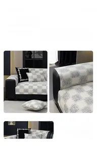Detail of grey and beige checkerboard cotton fabric with anti-slip texture on leather sofa