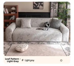 Close-up of light gray stretch sofa cover with decorative leaf texture and matching pillow