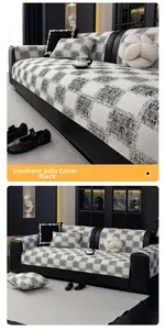 Detail of black and white plaid sofa cover with textured weave fabric and embroidery