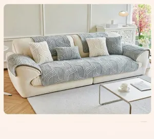 Close-up of modern wavy quilted sofa cover with thick soft plush texture in light blue grey