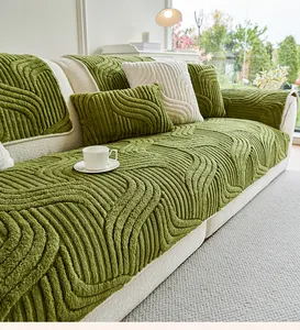 Detail of green wavy textured thick sofa cover and matching cushion on a modern sofa
