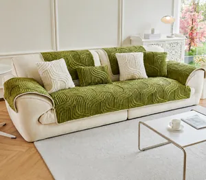 Detail of plush wavy textured sofa cover set in green and cream white colors