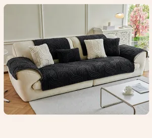 Detail of dark gray textured non-slip sofa cover with wave pattern plush fabric