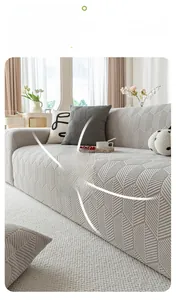 Detailed view of beige 360 full-cover elastic sofa slipcover with geometric jacquard texture