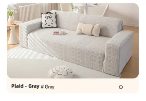 Close-up of gray stretch sofa cover featuring geometric grid pattern and textured fabric