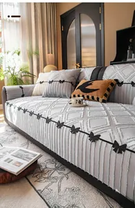 Detail of greyish-white high-precision sofa cover with rhombus patterns and black bow ties