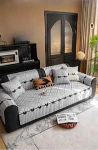 Detail of high-precision quilted sofa cover with diamond patterns and black bow accents