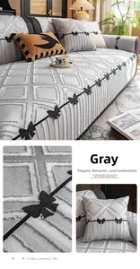 Close-up of gray high-density sofa cover with quilted rhombus pattern and bow embroidery