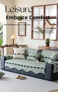 Close-up of light green chenille sofa cover with scalloped edges and black bow details