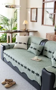Detail of mint green chenille sofa cover with bow embroidery and anti-scratch fabric