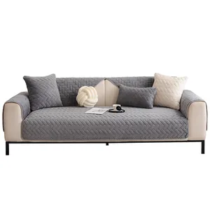 Gray quilted milk velvet sofa cover set with herringbone pattern on a cream couch