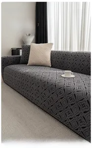 Detail of dark gray polar fleece sofa cover with geometric patterns and soft texture