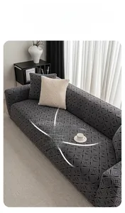Detail of soft fleece stretch sofa cover in dark grey with modern geometric pattern texture