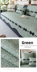Close-up of green chenille sofa cover showing thick textured fabric and black bow details