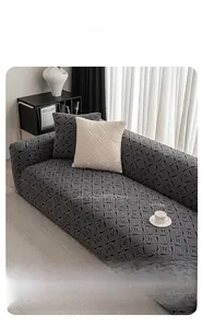 Close-up of dark grey polar fleece sofa cover with geometric textured elastic fabric