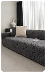 Detail of dark grey geometric jacquard stretch sofa cover with matching cushion covers